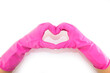 Photo top view of hands in pink gloves making heart with fingers on isolated blue background