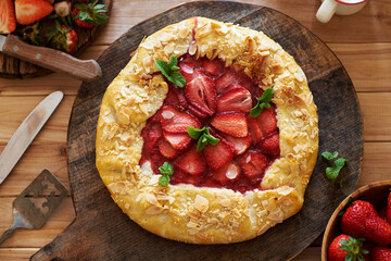 Sticker - Strawberry galette. Top view. Wooden background.