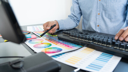 Poster - creative graphic designer choosing color scale for editing artwork while working in office.