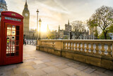 Fototapeta Londyn - Red telephone booth and Big Ben at sunrise in London. England