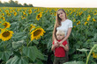 Portrait of young mother and little son in sunflower field. Summer outside the city