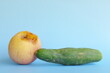 © sulit.photos - Rotten, bruised, stale or bad apple and cucumber isolated in blue background. Food waste and poor agricultural crop quality concept.