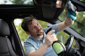 happy man cleaning his car