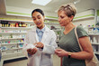 © StratfordProductions - Senior woman with young pharmacist checking medicine dosage and ingredients with expiry date standing near shelf in chemist shop