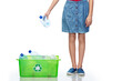 © Syda Productions - recycling, waste sorting and sustainability concept - girl puts plastic bottles in green box over white background