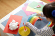 © M-image - young girl making paper rainbow craft for homeschooling