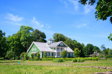 The old green beautifull house or mansion of P.A. Gannibal (a relative of A.S. Pushkin) in the Petrovskoe, Pushkinskie Gory, Family estate ancestors Alexander Pushkin's manor on a sunny summer day.