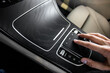 hand holding a car touchpad