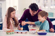 © Monkey Business - Father With Two Children In Kitchen At Home Having Fun Baking Cakes Together