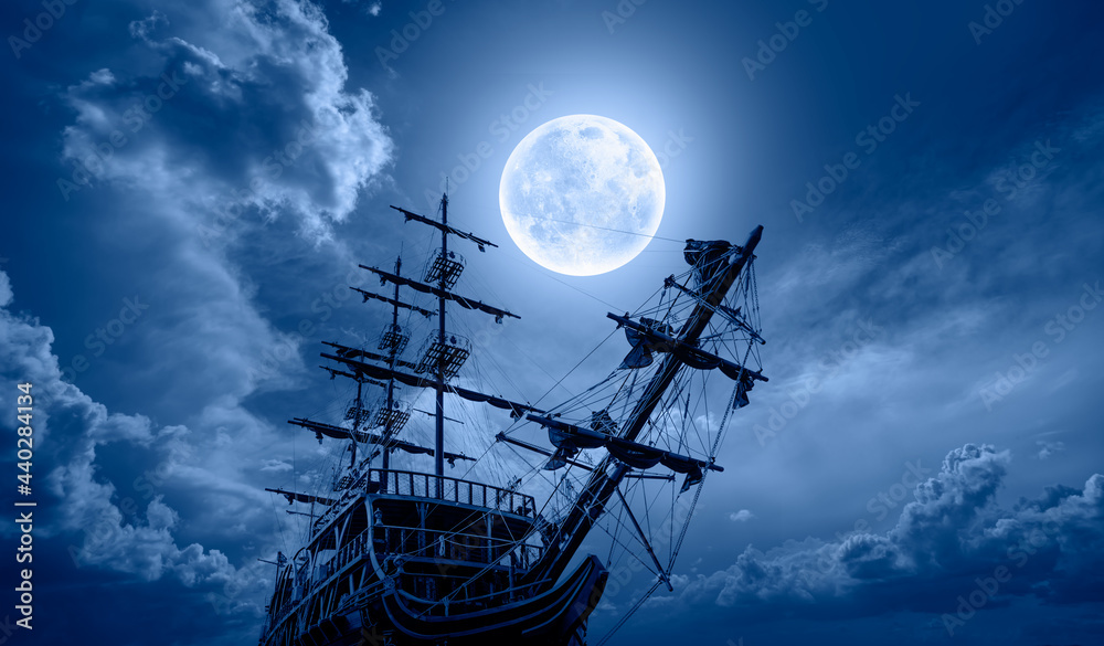 Sailing old ship in storm sea - Night sky with moon in the clouds ...