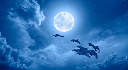 Poster - A flock of dolphins jumping above the clouds with full blue moon 