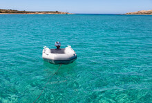 Dinghy Inflatable Boat On Turquoise Blue Sea Water