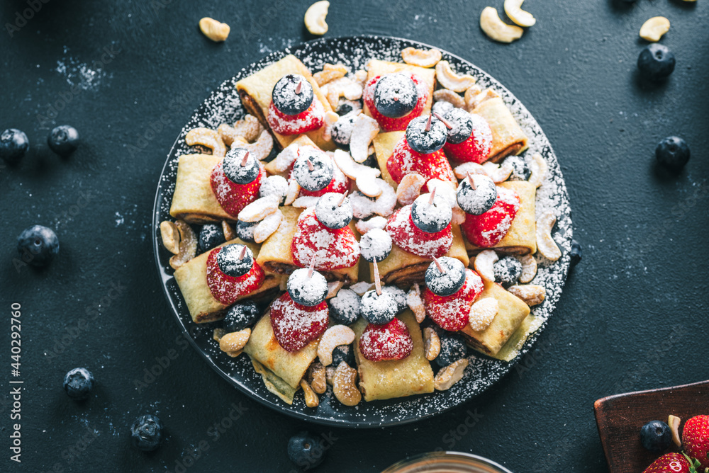 Breakfast pancake. A healthy breakfast with fruit. Pancake with fruit. Iced coffee and fruit. Dark background with pancakes and fruit. - obrazy, fototapety, plakaty 