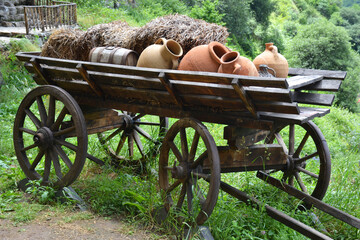 Old wooden cart with clay jugs