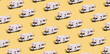 © Alina - Pattern of a toy van on a yellow background. Minimalistic summer family vacation, staycations concept