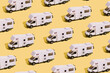 © Alina - Pattern of a toy van on a yellow background. Minimalistic summer family vacation, local trip concept