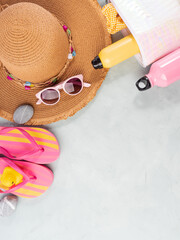 Canvas Print - Summer sea vacation accessories. Straw hat, flip flops, sun spray, sunglasses on stone background.