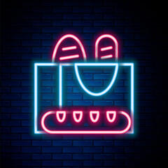 Poster - Glowing neon line French baguette bread icon isolated on brick wall background. Colorful outline concept. Vector