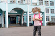 © Надежда Урюпина - a little girl near the school with a backpack in a mask and an antiseptic in her hands, the concept of prevention covid-19