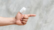 A thumb of men is injured on a gray background.