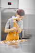 © Anischenko - Pastry chef girl prepares fresh cakes at her small production facility