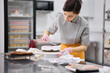© Anischenko - A bright pastry chef girl is engaged in the preparation of a cake