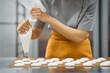 © Anischenko - Pastry chef girl prepares fresh cakes at her small production facility