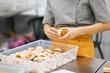 © Anischenko - A bright girl holds fresh cakes and macaroons in her hands