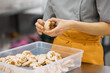 © Anischenko - A bright girl holds fresh cakes and macaroons in her hands