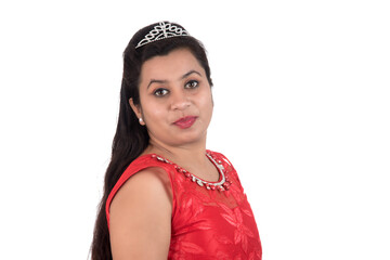 Young girl in red dress posing on white background