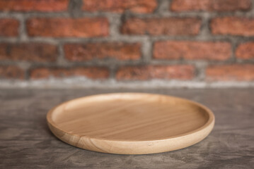 empty wood dish on blur old brick wall background 