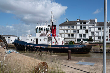 Wall Mural - Close-up of a tugboat in a city port in France