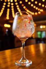 Sticker - Selective focus shot of a white alcoholic cocktail full of ice on a wooden surface in a bar