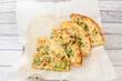 Portions of traditional hindu naan garlic bread on absorbent paper and lots of parsley