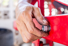 Close Up Of Repair Mechanic Hands Install Bolts & Nuts Of Piping, Worker's Hand Tightens The Nut On The Bolt