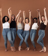 © Artem Varnitsin - Six happy women raised their hands up together over brown background