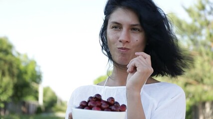 Wall Mural - woman eating fruits. Happiness. Woman smile. Video. 