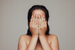 © Jacob Lund - Close up of woman hiding her face with hands