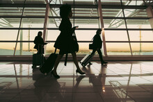 Silhouette Of People Walking At Airport Terminal