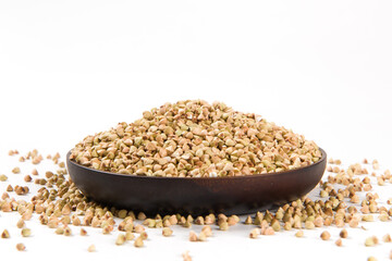 Pile of raw buckwheat isolated on white background.