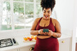 © (JLco) Julia Amaral - Body positive woman messaging on smart phone