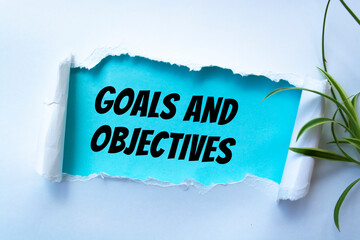 Canvas Print - Goals and Objectives words written under torn paper.