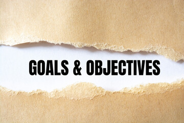 Canvas Print - Goals and Objectives words written under torn paper.