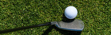 Golf Detail, White Golf Ball On The Fairway With A Golf Club Getting Ready To Hit The Next Shot
