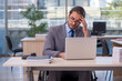 © Elnur - Young male employee in wheel-chair working in the office