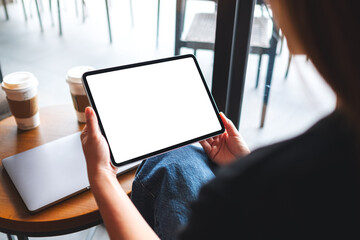 Mockup image of a woman holding digital tablet with blank white desktop screen