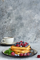 Wall Mural - Vanilla Belgian waffles with berries and a cup of coffee for breakfast.