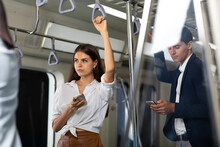 Young Beautiful Woman Passenger Using Smartphone While Going To Working By Public Sky Electric Train