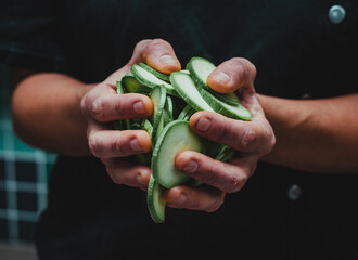 Wall Mural - Closeup shot of a person holding sliced zucchini