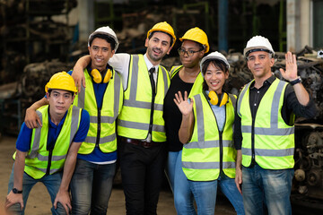 Unity and teamwork concept. team standing hands together. Professional Mechanical Engineer team Working at Second-hand spare parts of old car parts warehouse store. High five.